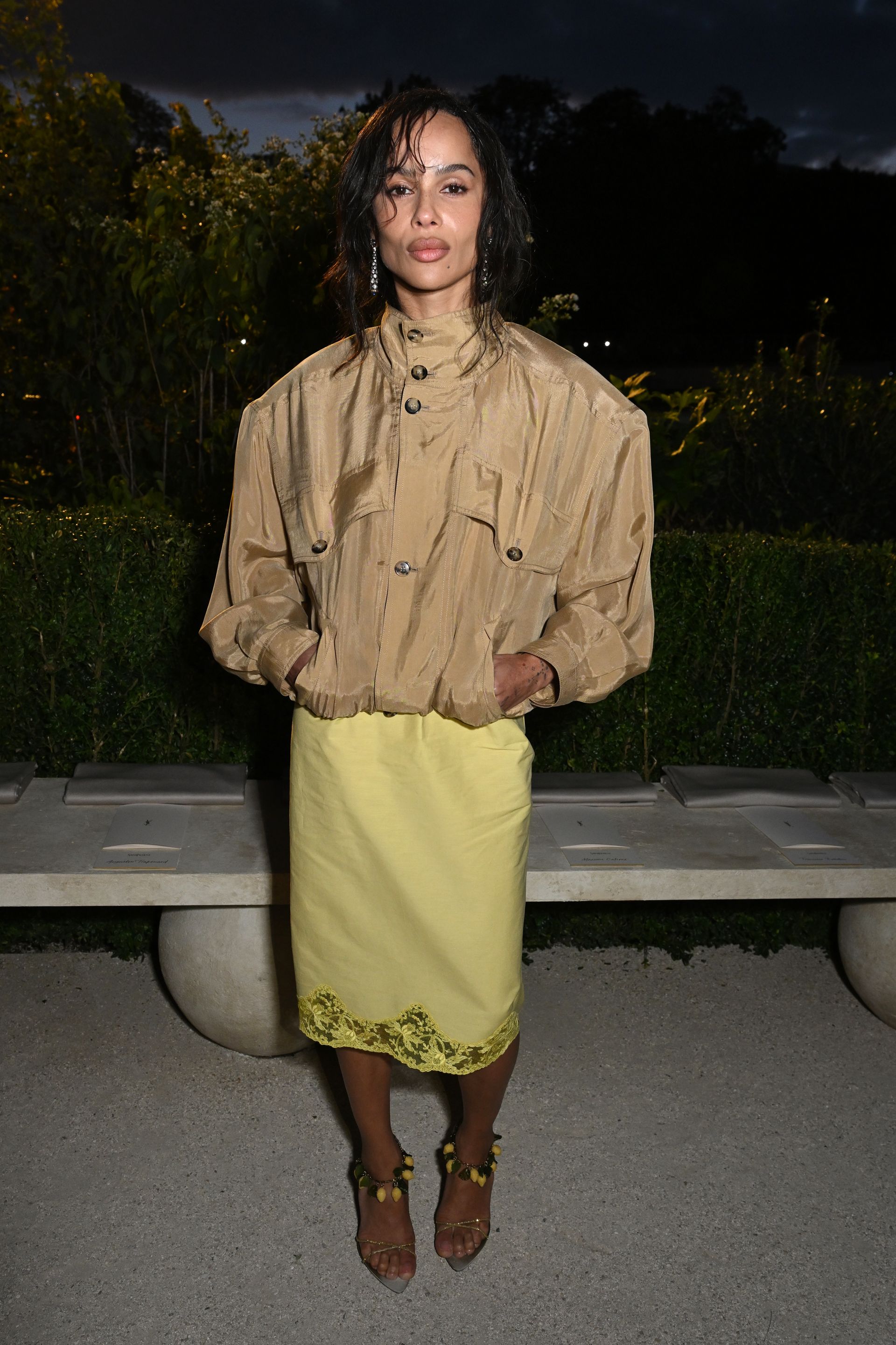Zoë Kravitz in a funnel neck jacket and lace-trim skirt