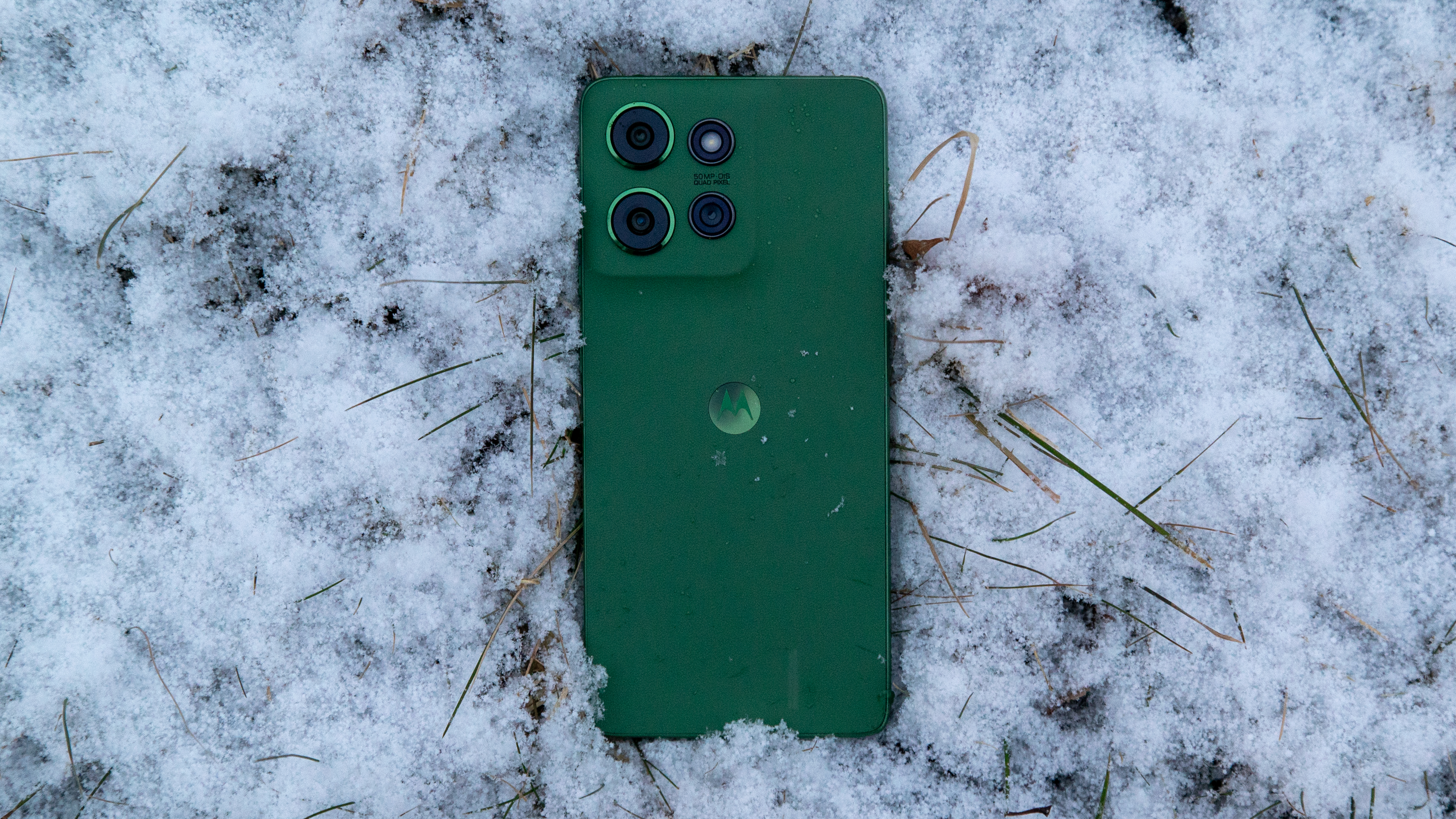 The Moto G Power 2025 face down in snow