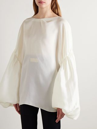 Billowy white Khaite blouse with puff sleeves