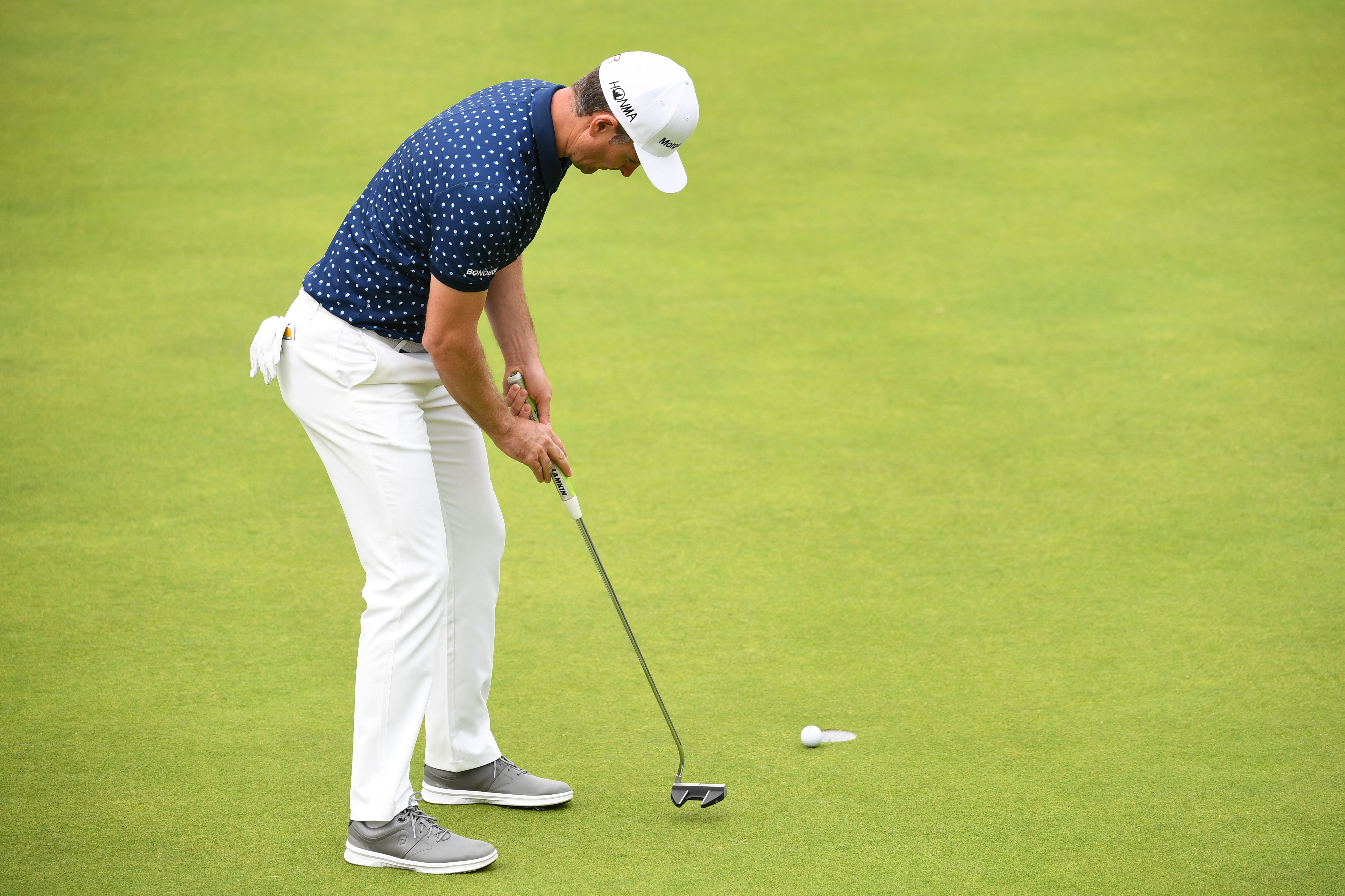 Justin Rose putts on the 18th green during the third round of The Open Championship