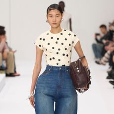 Model wears horseshoe jeans on the Acne runway.