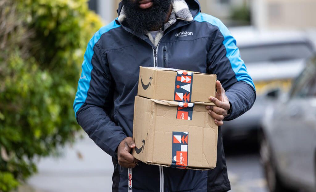 an amazon delivery driver delivering an amazon prime day parcel