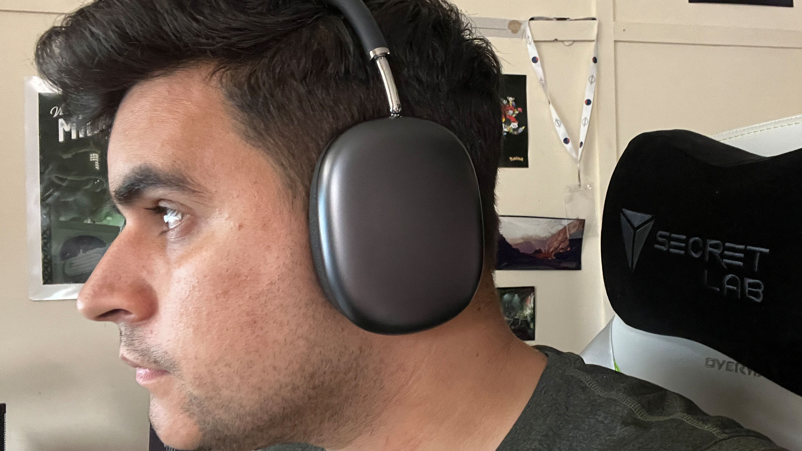 The author wearing the Apple AirPods Max in a computer gaming chair