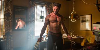 Wolverine (Hugh Jackman) stands shirtless with his claws out.