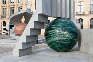 sculpture installation of concrete blocks and colourful spheres