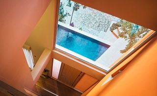 The dominant colour is a soft and energising tropical orange which occupies the central atrium and external walls of the house