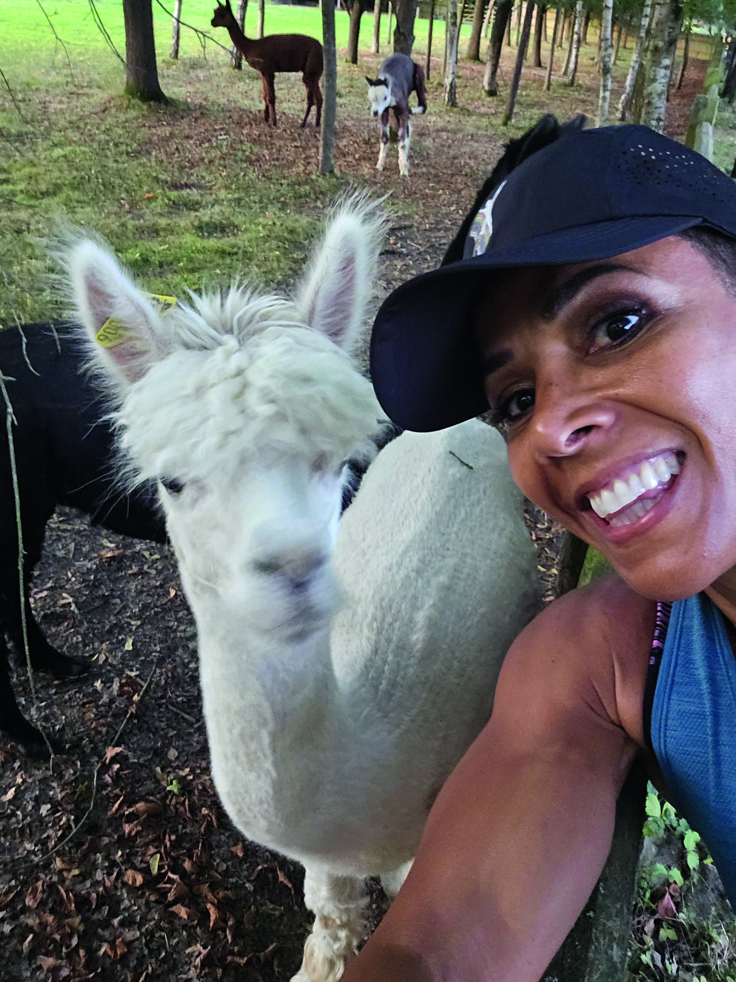 Dame Kelly Holmes in a selfie with various alpacas