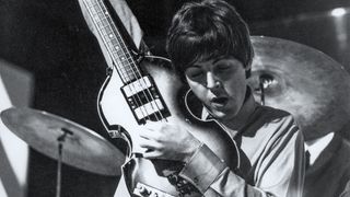 Paul McCartney of English rock and pop group The Beatles tunes up his Hofner 500/1 violin bass guitar on stage during rehearsals for the ABC Television music television show 'Thank Your Lucky Stars' Summer Spin at Teddington Studios in London on 11th July 1964. The band would go on to play four songs on the show, A Hard Day's Night, Long Tall Sally, Things We Said Today and You Can't Do That.