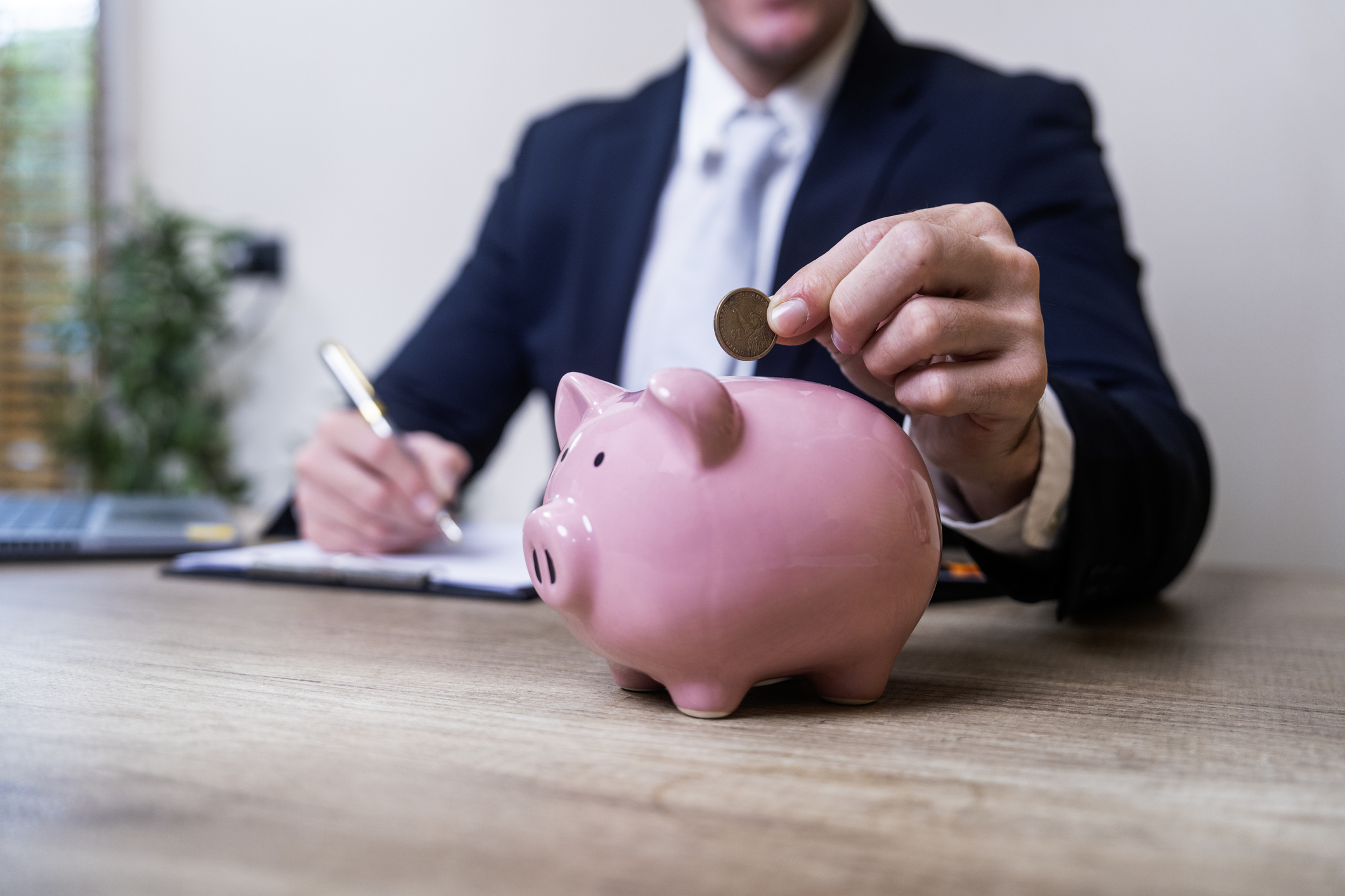 Employee saving into a pension piggy bank