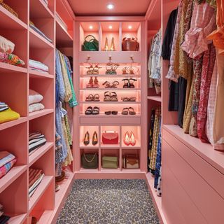 Pink walk in wardrobe with leopard print carpet