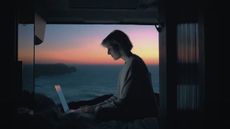 Asus promotional video for its new laptop showing a woman working on a computer overlooking the sea