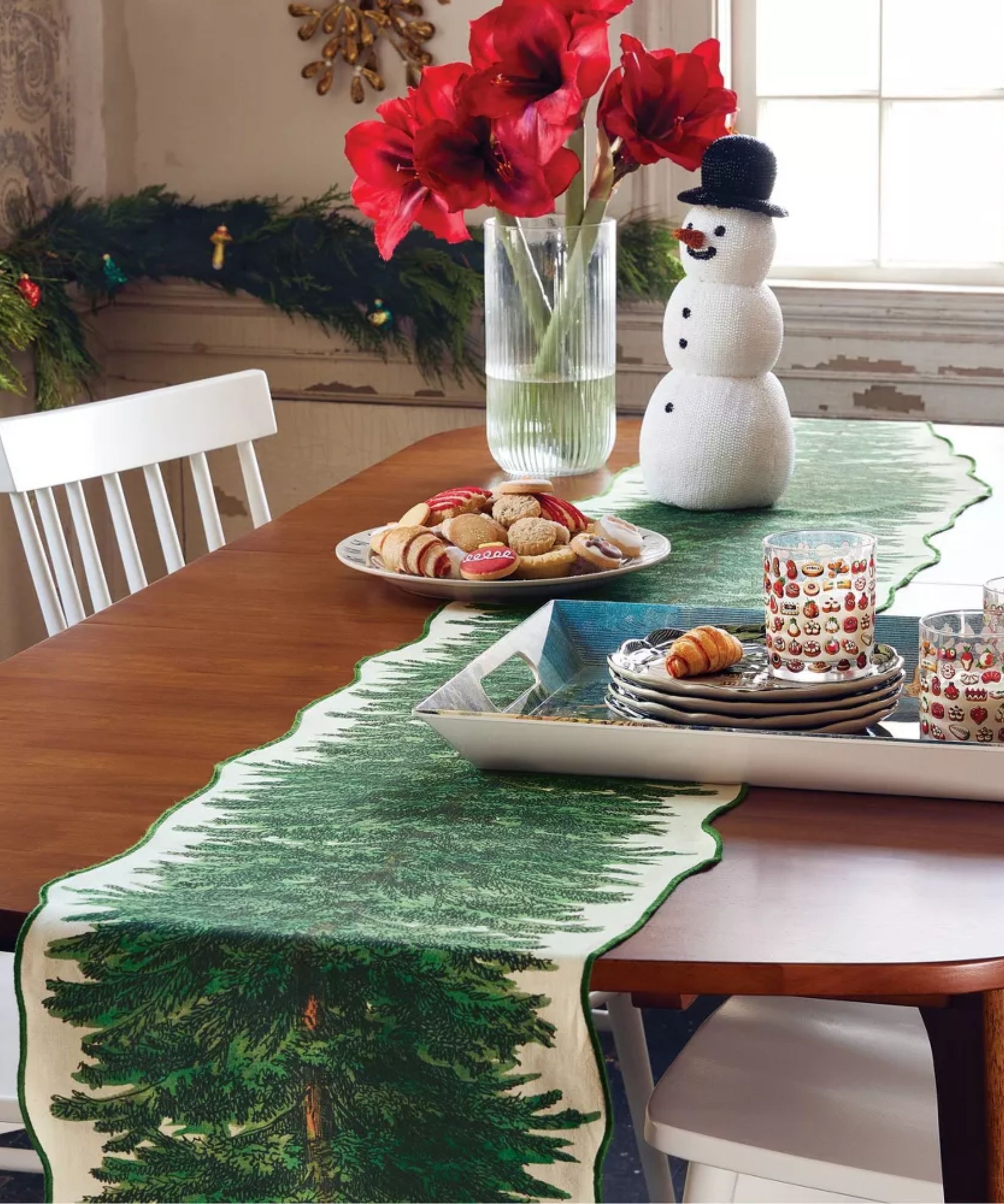 Wood table with Christmas tree runner and snowman ornament