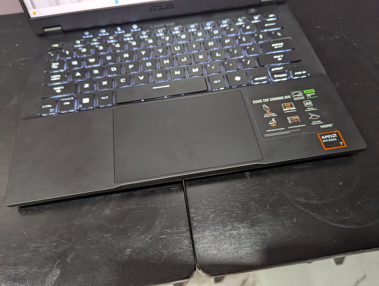Above-angle shot of the keyboard and touchpad on the Asus TUF Gaming A14.