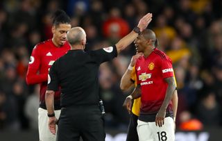 Mike Dean gives Manchester United’s Ashley Young, right, his marching orders