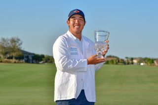 Byeong Hun An holds a trophy