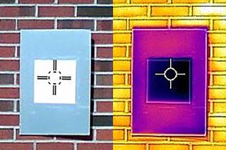 A photo taken by an infrared camera demonstrates how the white paint (dark square) cools the surrounding board (rectangle) below ambient temperature.