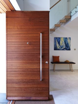 timber front door with large vertical handle