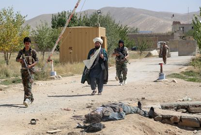 A Taliban insurgent lies dead after an attack on a prison in Ghanzi, Afghanistan