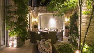 Courtyard garden with a variety of outdoor lighting installed as wall lights and floor lights