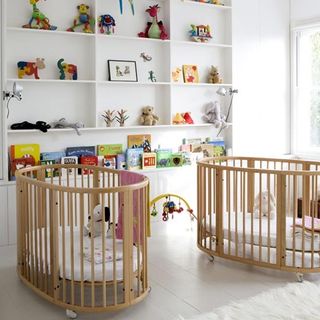 twin nursery with open shelves and white walls