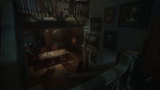 Descending the staircase of a spooky mansion in Layers of Fear.