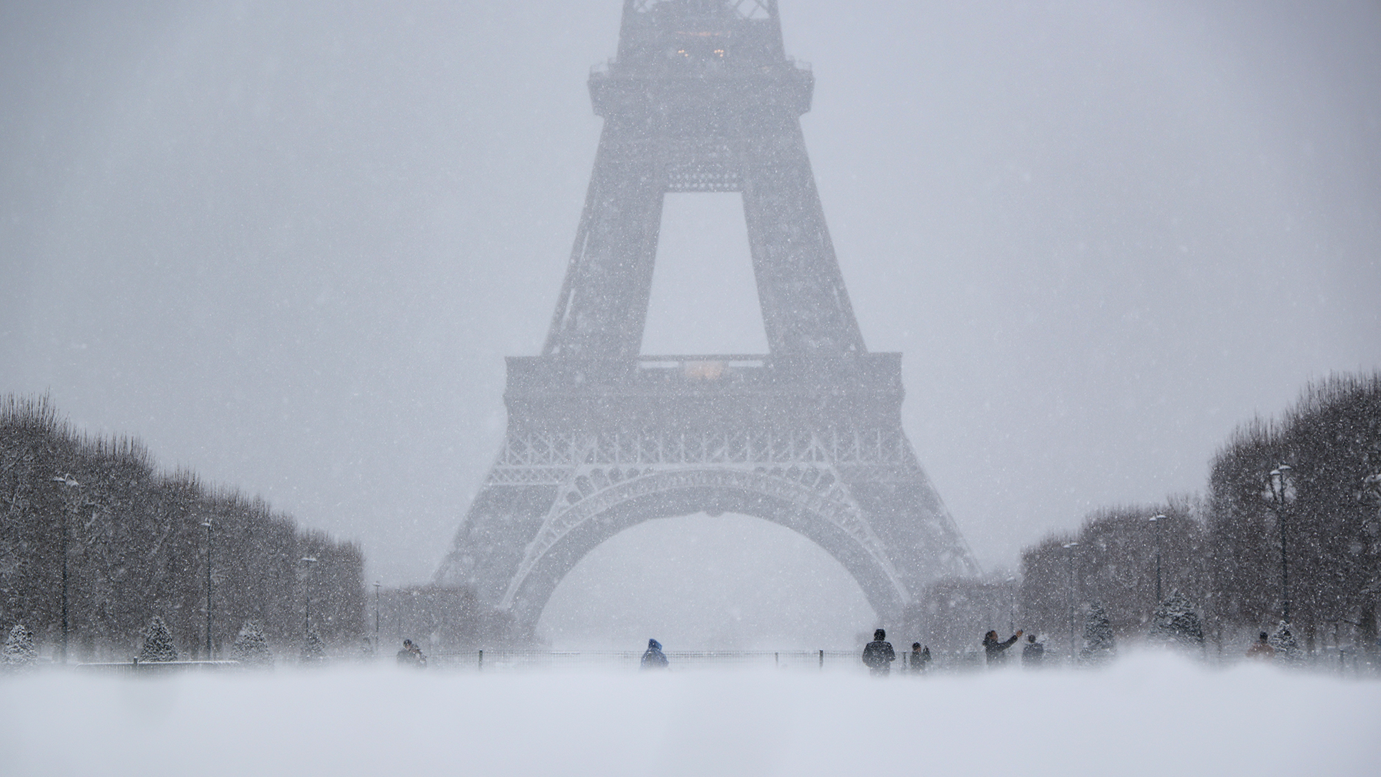 A snowstorm blows over the Champ de Mars near the Eiffel Tower in Paris, France