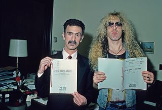 Snider and Frank Zappa hold up papers relating to the 1985 PMRC Senate hearing