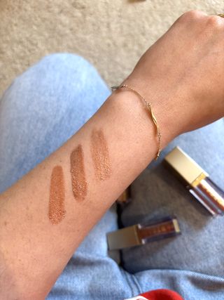 Mica Ricketts showing swatches of Stila Glitter & Glow Liquid Eye Shadow on her arm