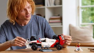 A person with the Lego F1 Senna set