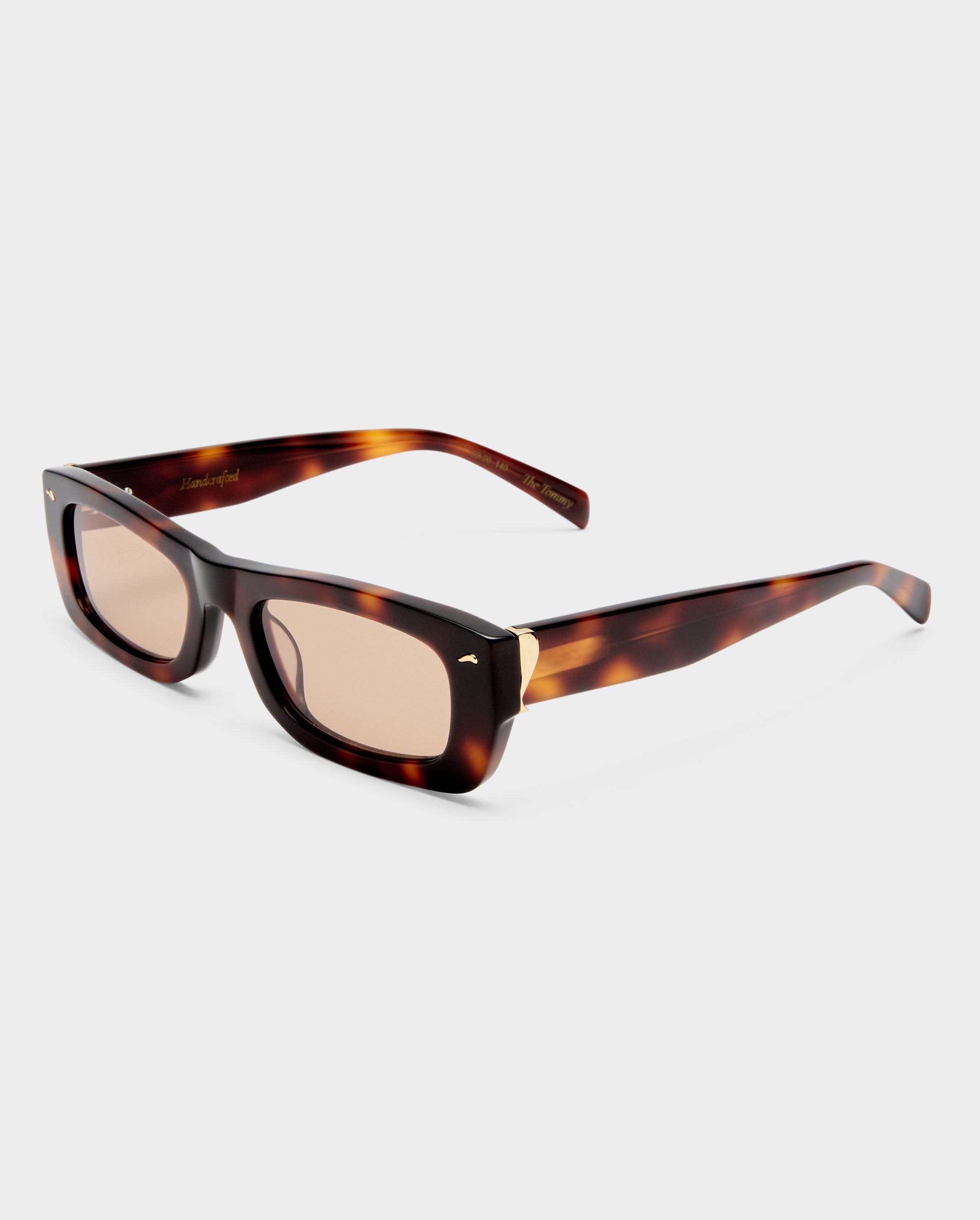 Thick rectangle, tortoise shell sunglasses with pink hued lenses.