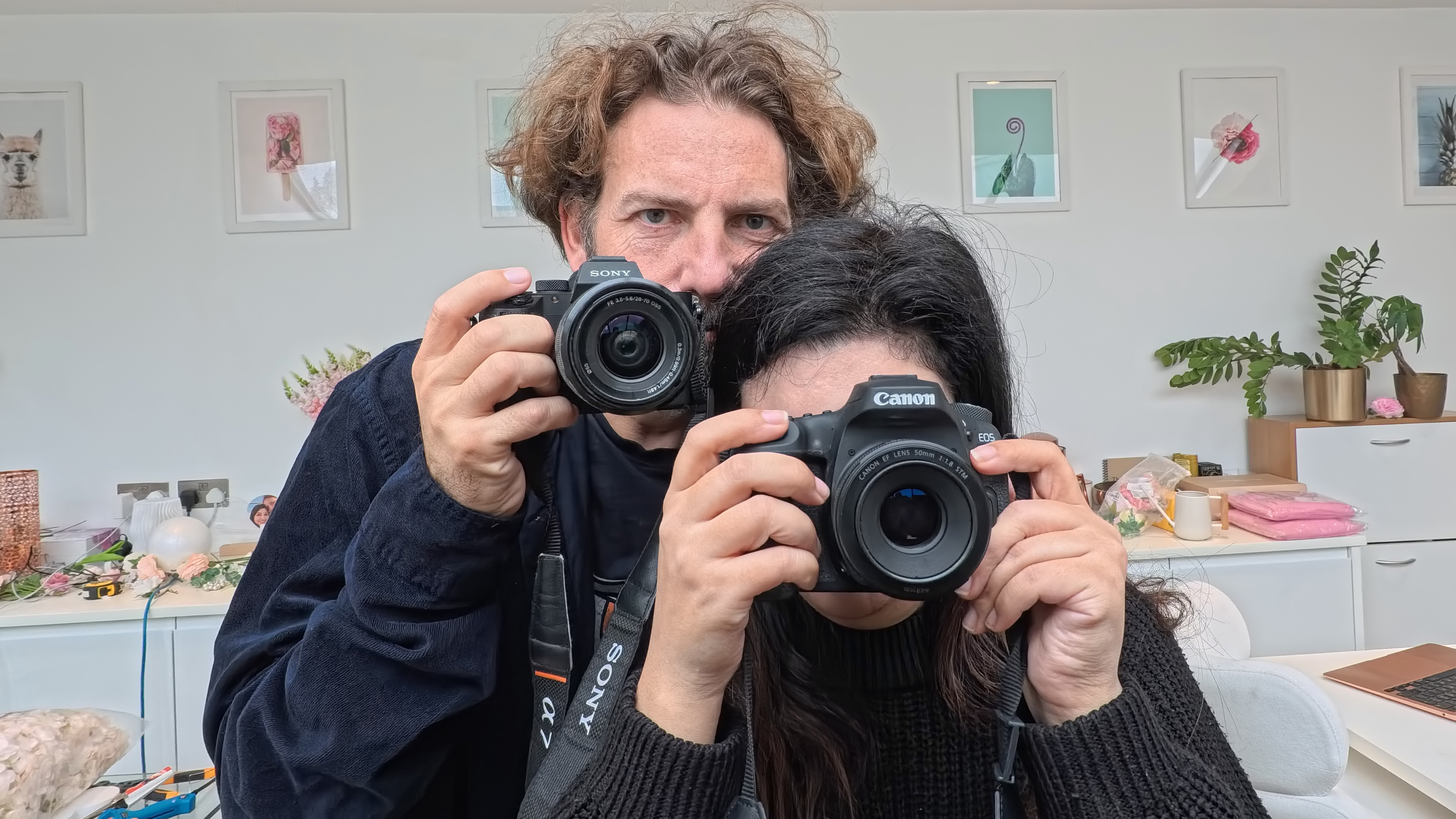 Adam Juniper and Ariane Sherine holding cameras