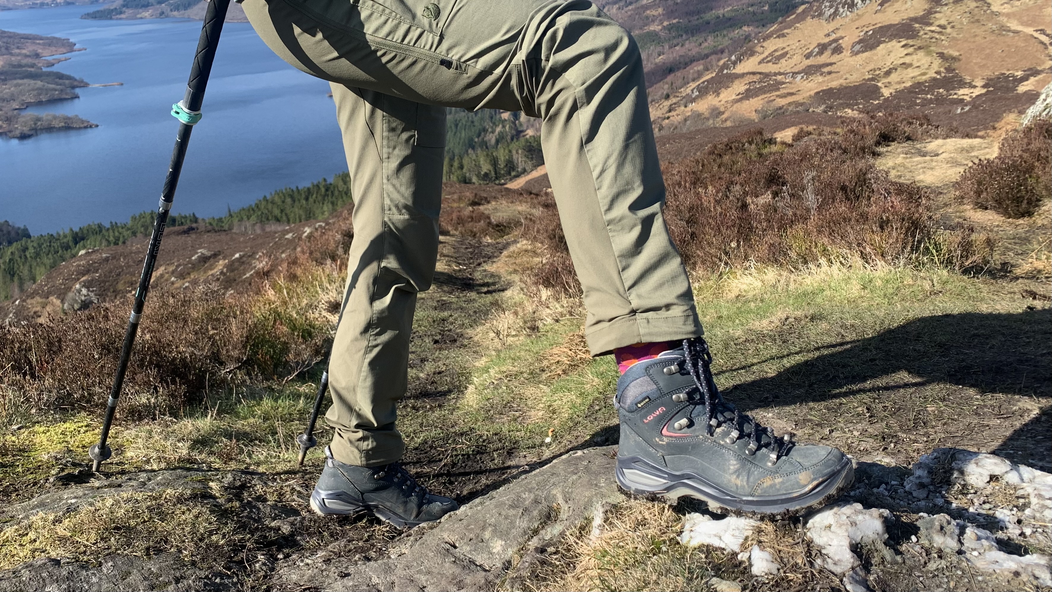 Hiker's feet on a mountain wearing the Lowa Renegade Evo GTX Mid hiking boots