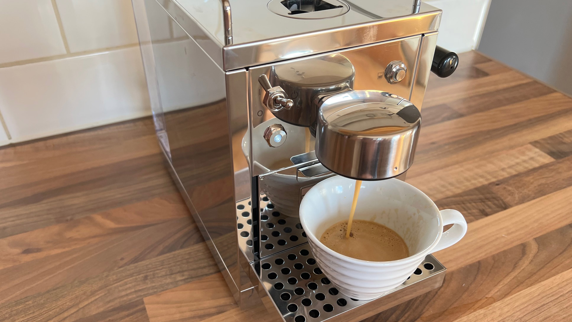 The Grind One Pod machine being used to brew an espresso