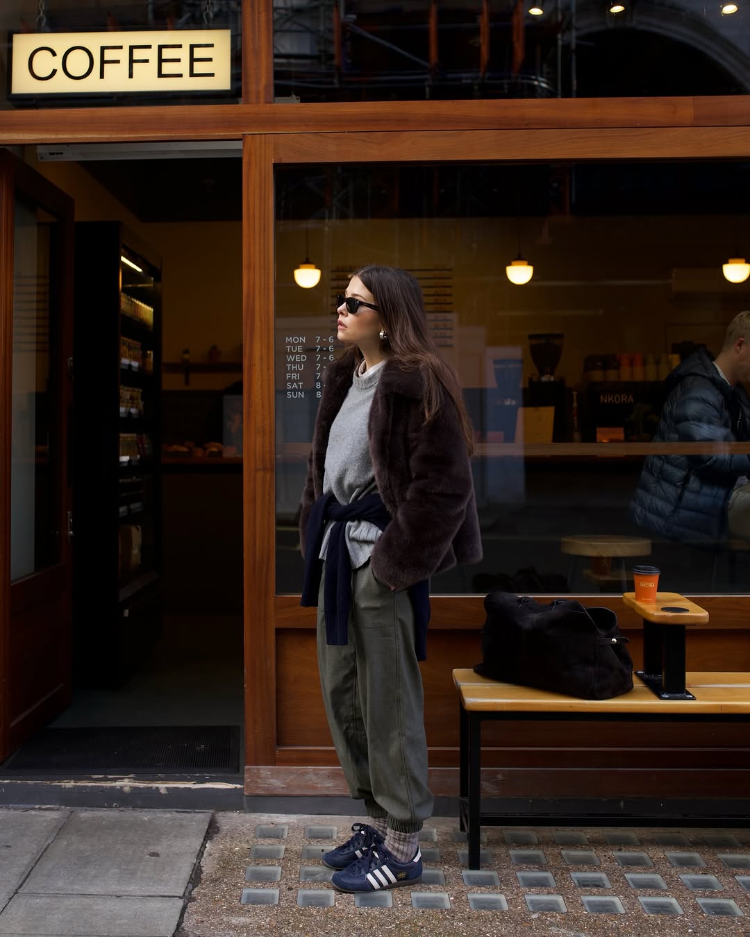 Woman wearing layering outfit idea 2026.