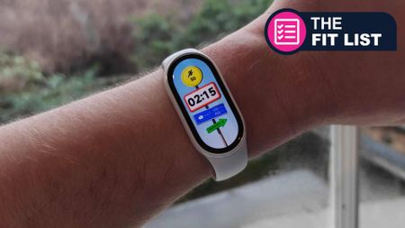 Caucasian man wearing xiaomi fitness tracker with TR Fit List badge