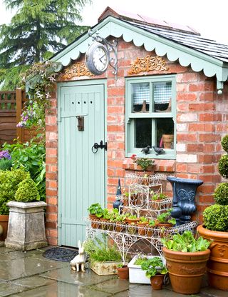 garden shed with brick wall and potted plant