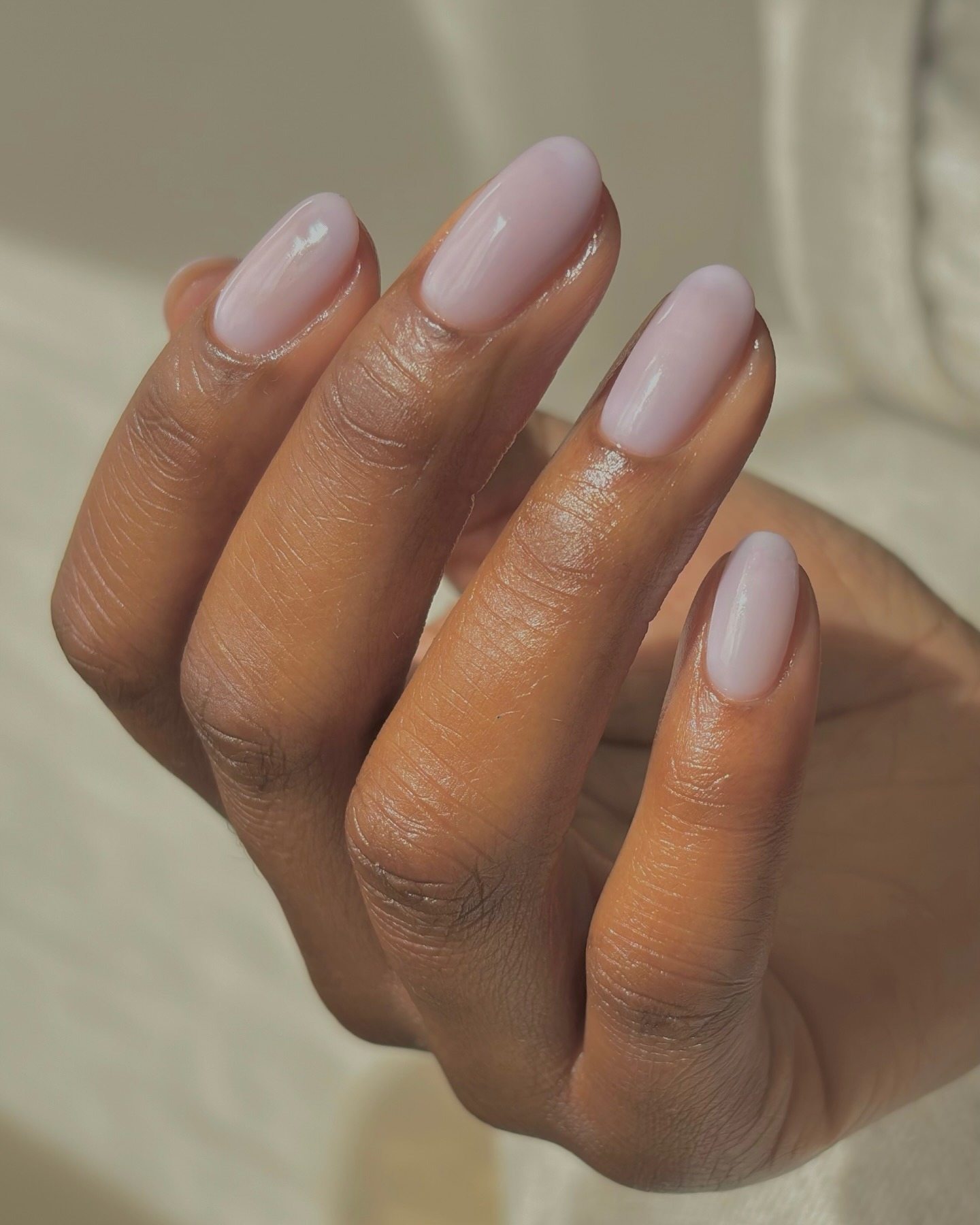 a sheer milky lilac manicure