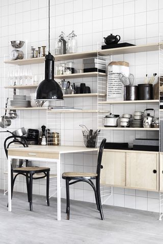 Chrome and wood open shelving units in a kitchen