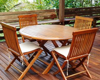 Teak outdoor furniture set on wooden deck