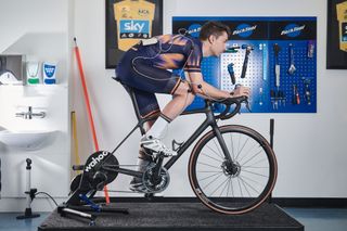 Male cyclist riding his bike during a bike fit with Phil Burt