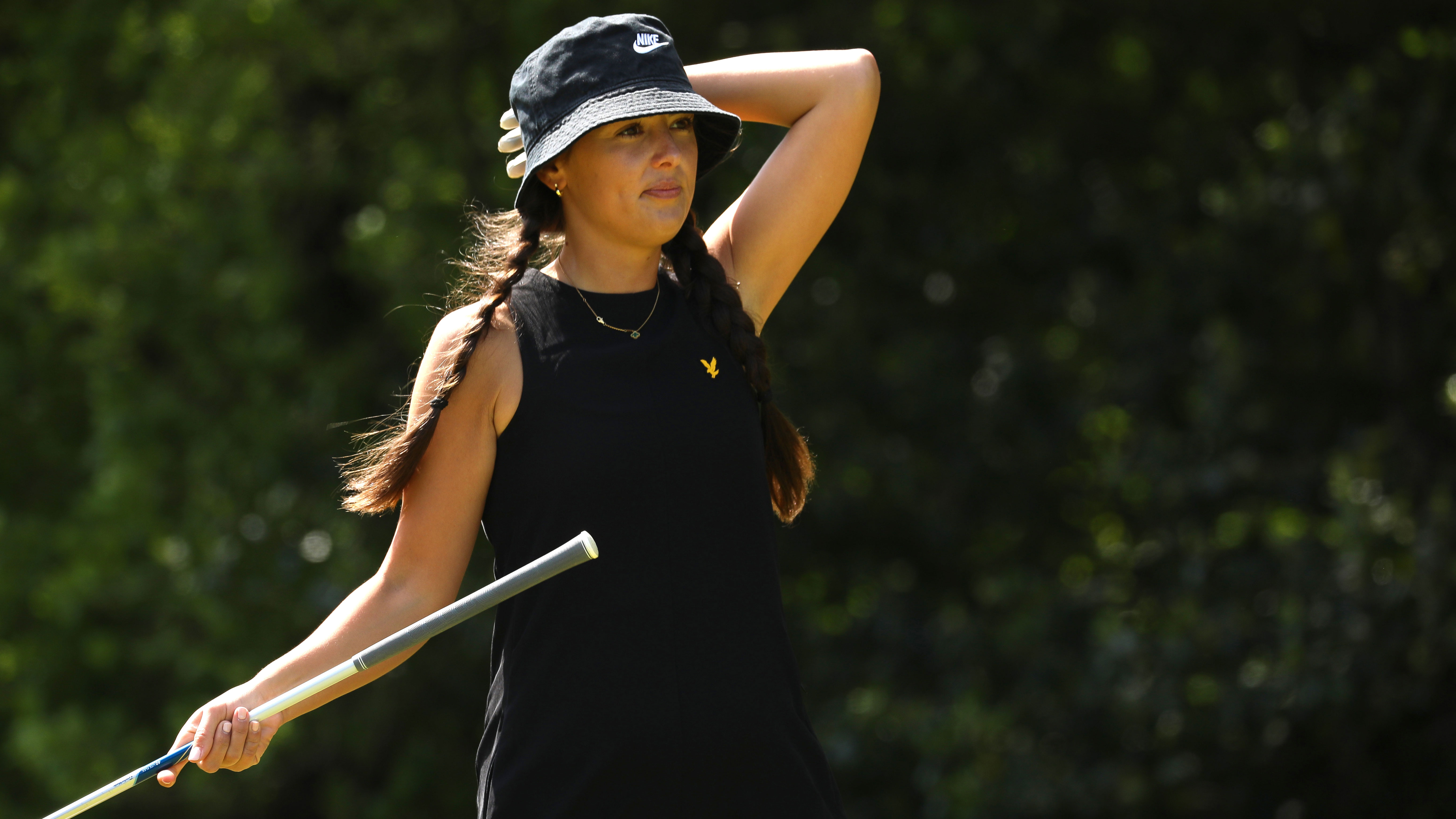 Golfer Beth reacts to a golf shot with frustration