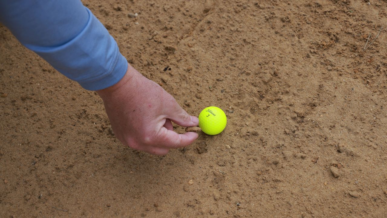 A 'stone' in the bunker turns out to be a clump of wet sand...