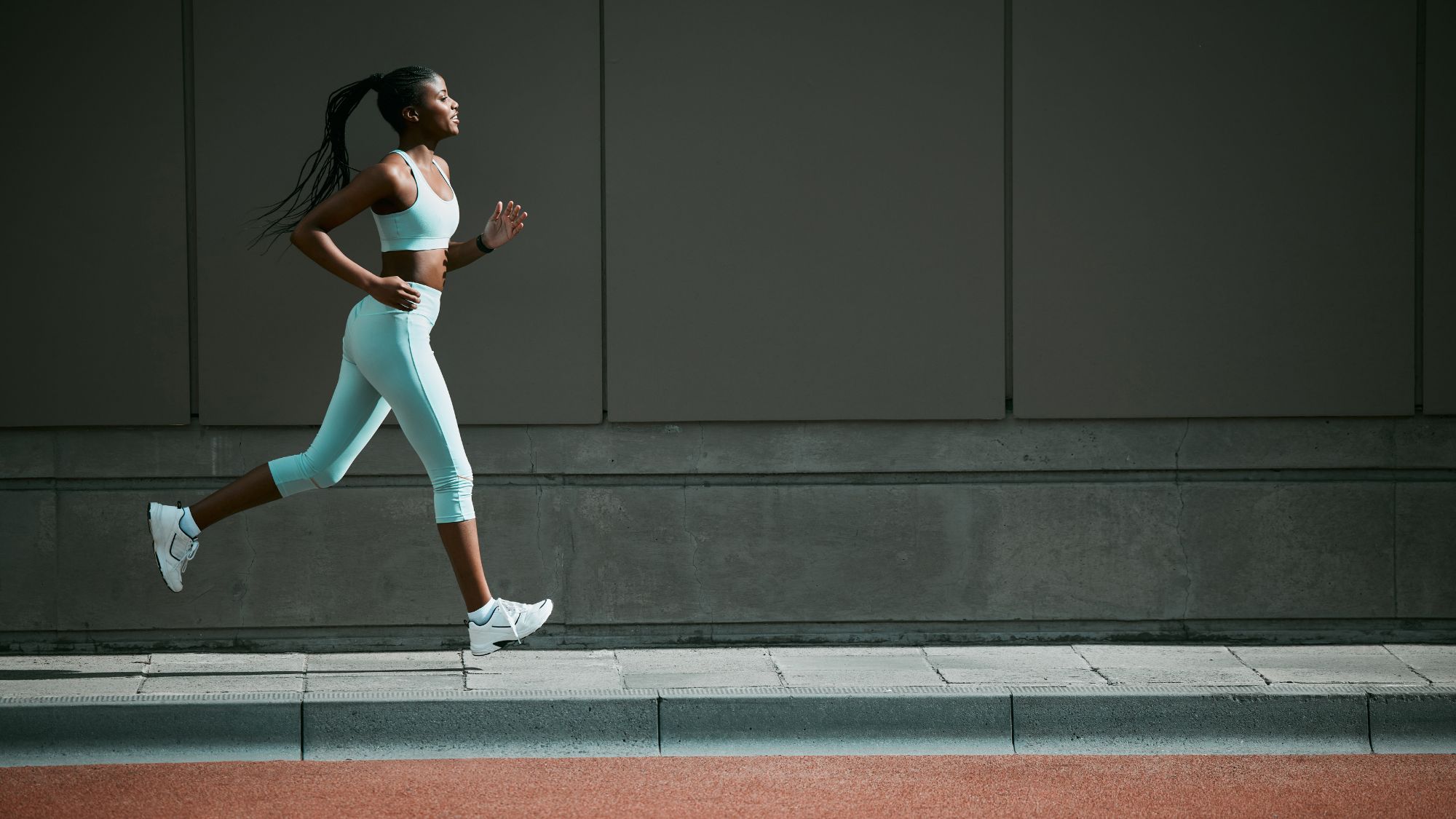 How to run for further: A woman on a run in matching blue sports kit