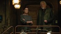 A woman and a man standing together in a dark bunker