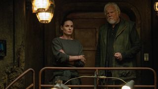 A woman and a man standing together in a dark bunker