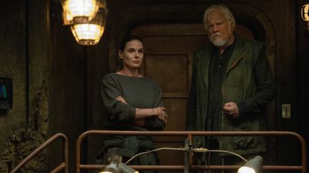 A woman and a man standing together in a dark bunker