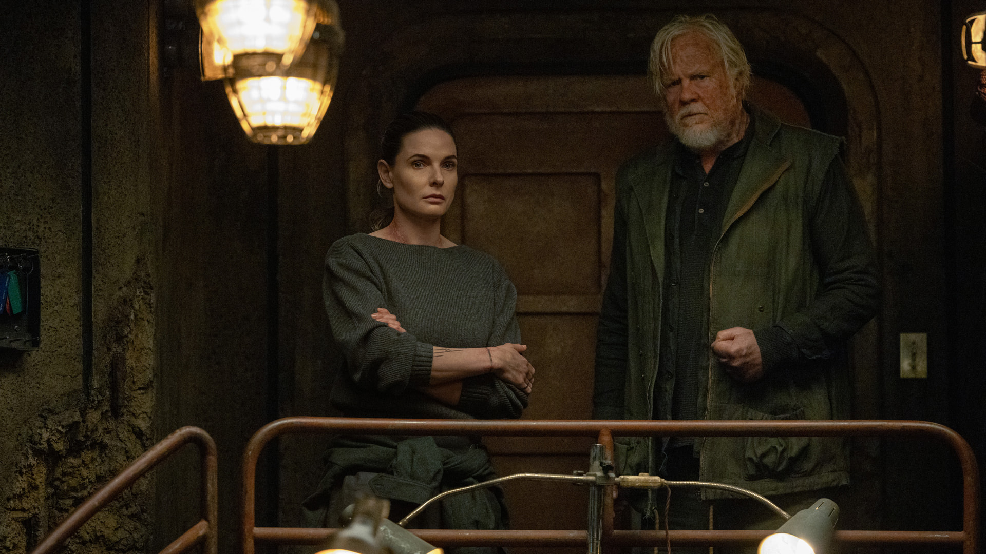 A woman and a man standing together in a dark bunker