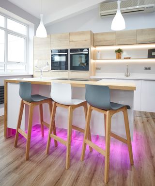 breakfast bar with pink neon lighting at ground level