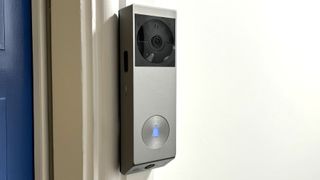 EZVIZ EP3x Pro video doorbell mounted beside blue door