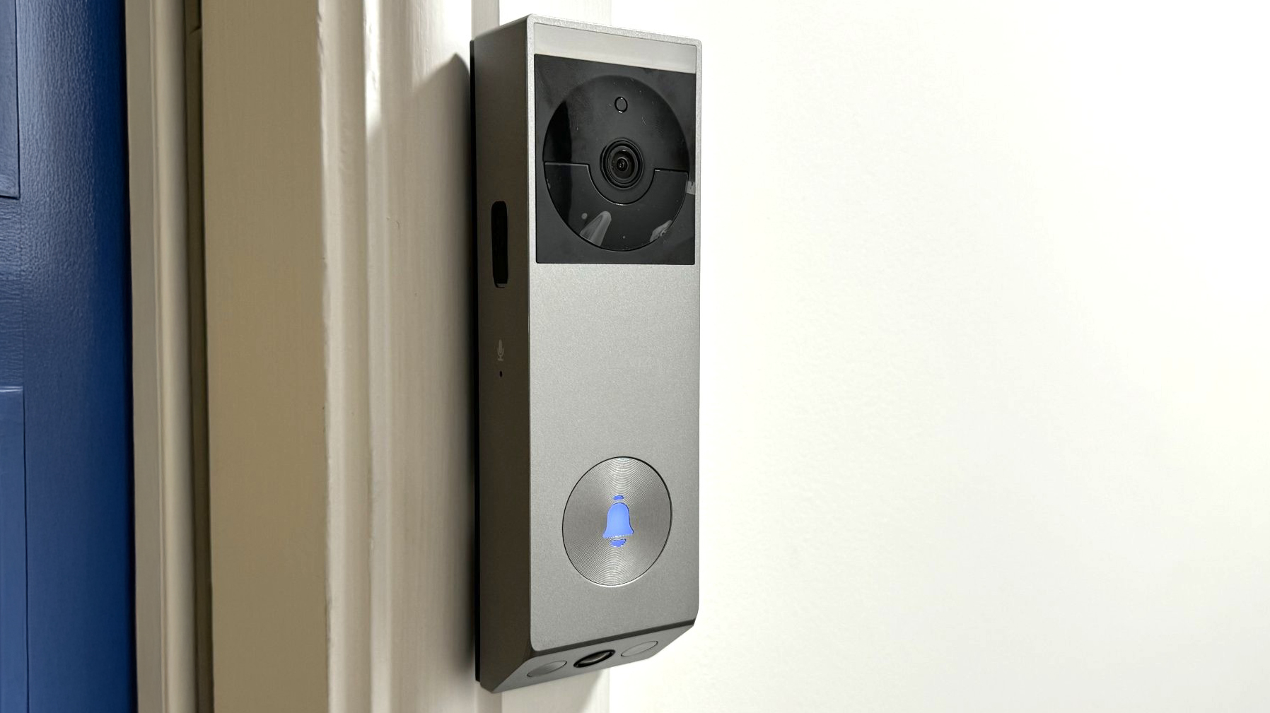 EZVIZ EP3x Pro video doorbell mounted beside blue door